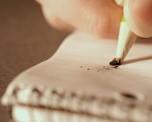 Closeup of A Hand Holding Broken Pencil